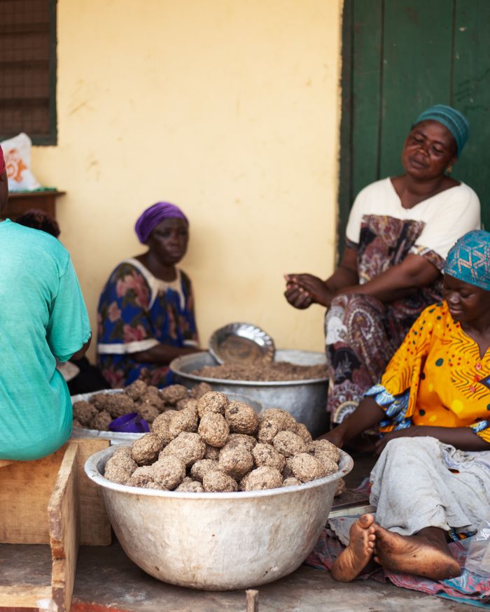 Women processing nuts into pressed balls in northern Ghana.
