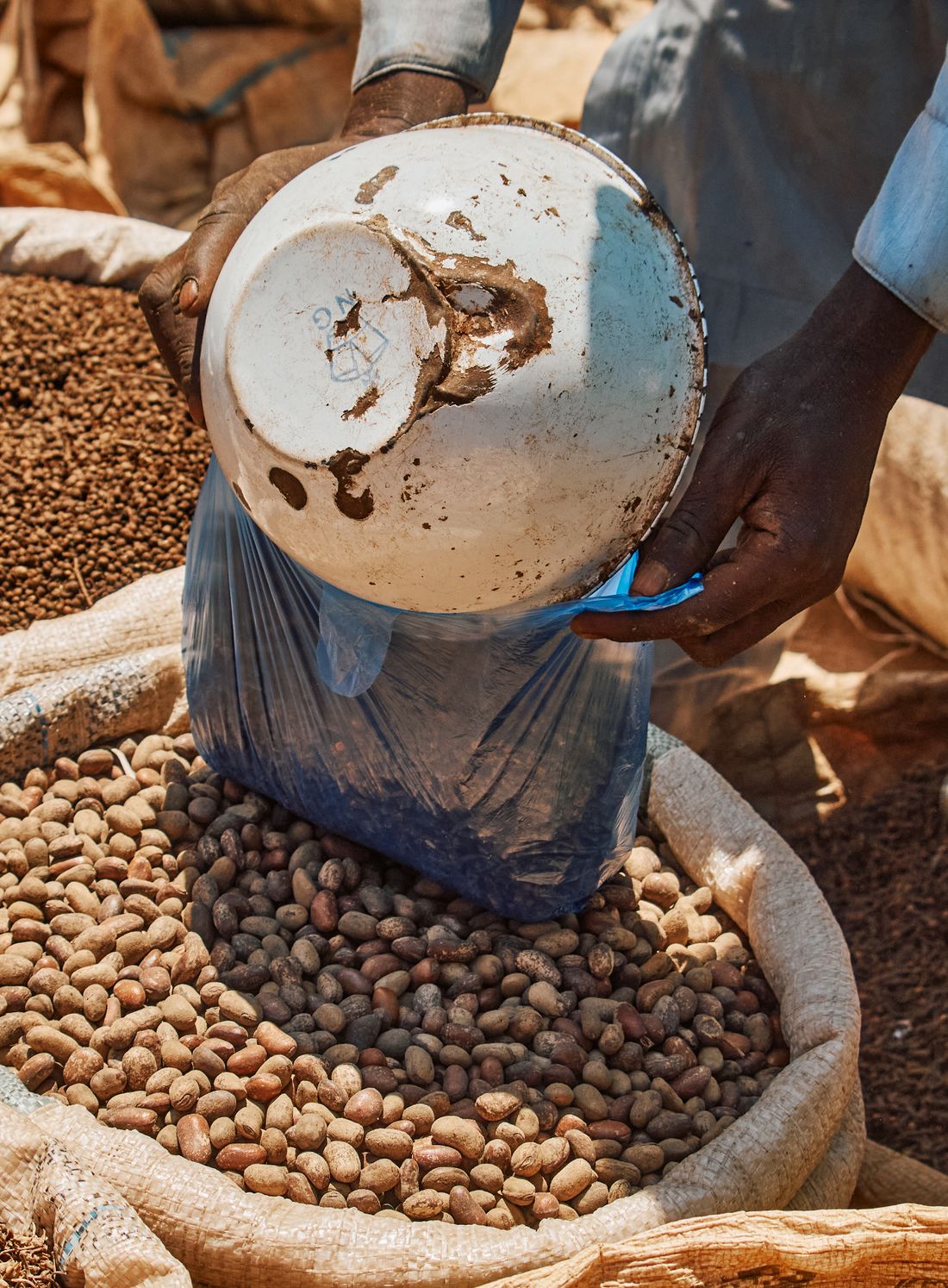 Grain being measured and bagged at market.